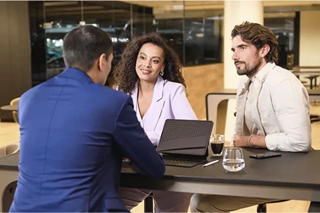 Customers talking to a Mercedes-Benz dealer